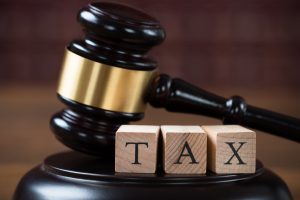 Closeup of tax wooden blocks on mallet at table in courtroom